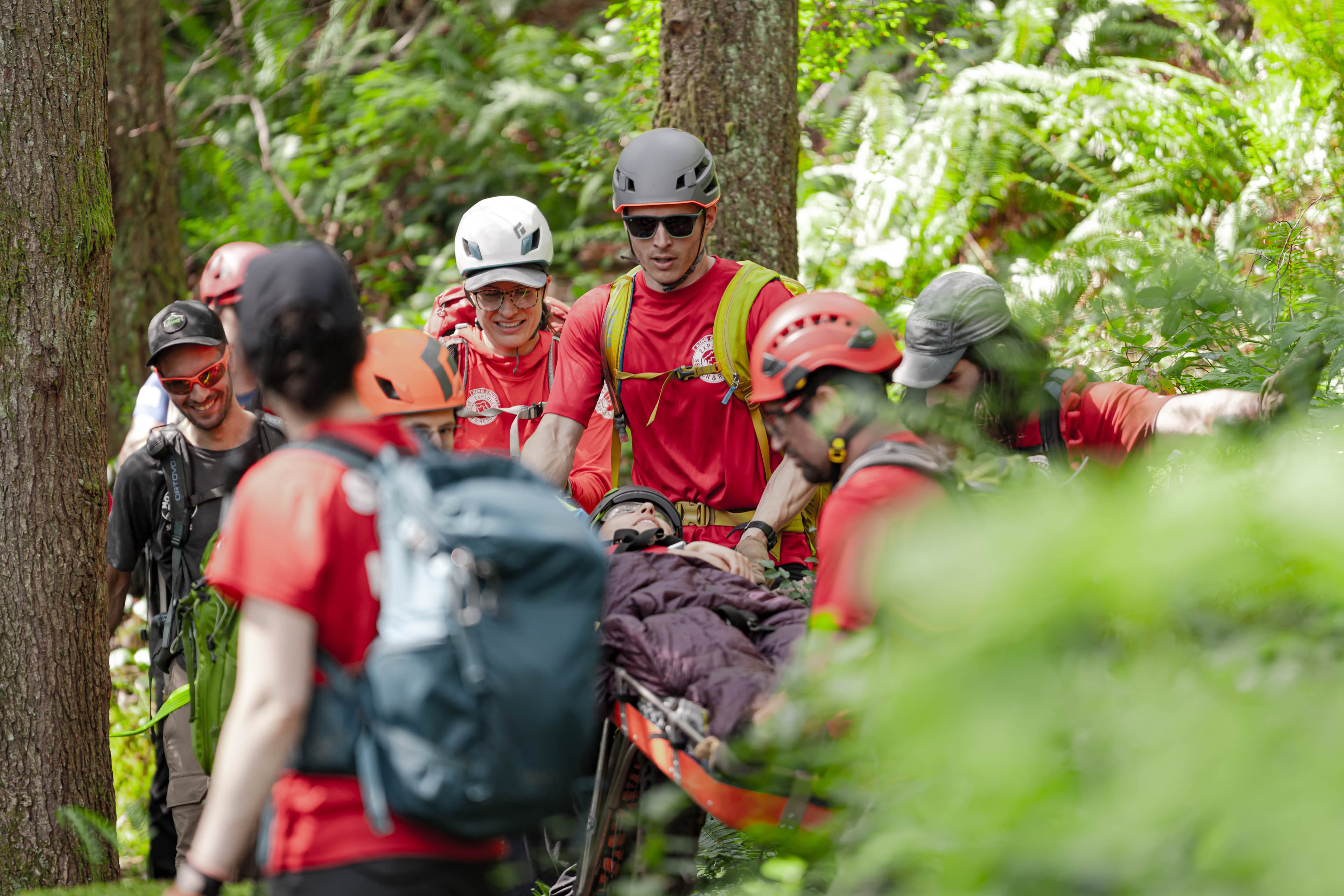 Rescuers moving the litter down the trail