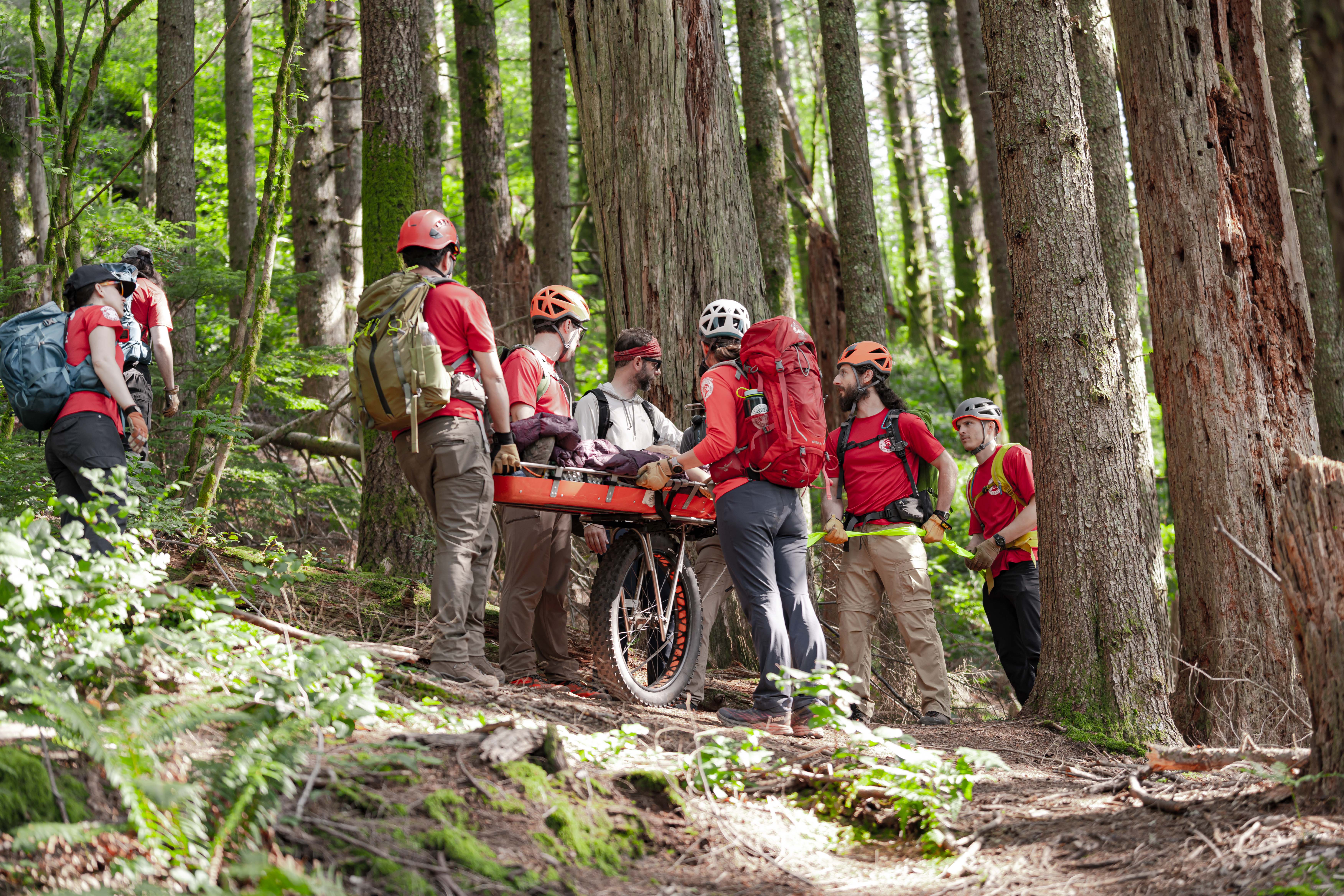 Rescuers preparing the litter to take a subject down a trail