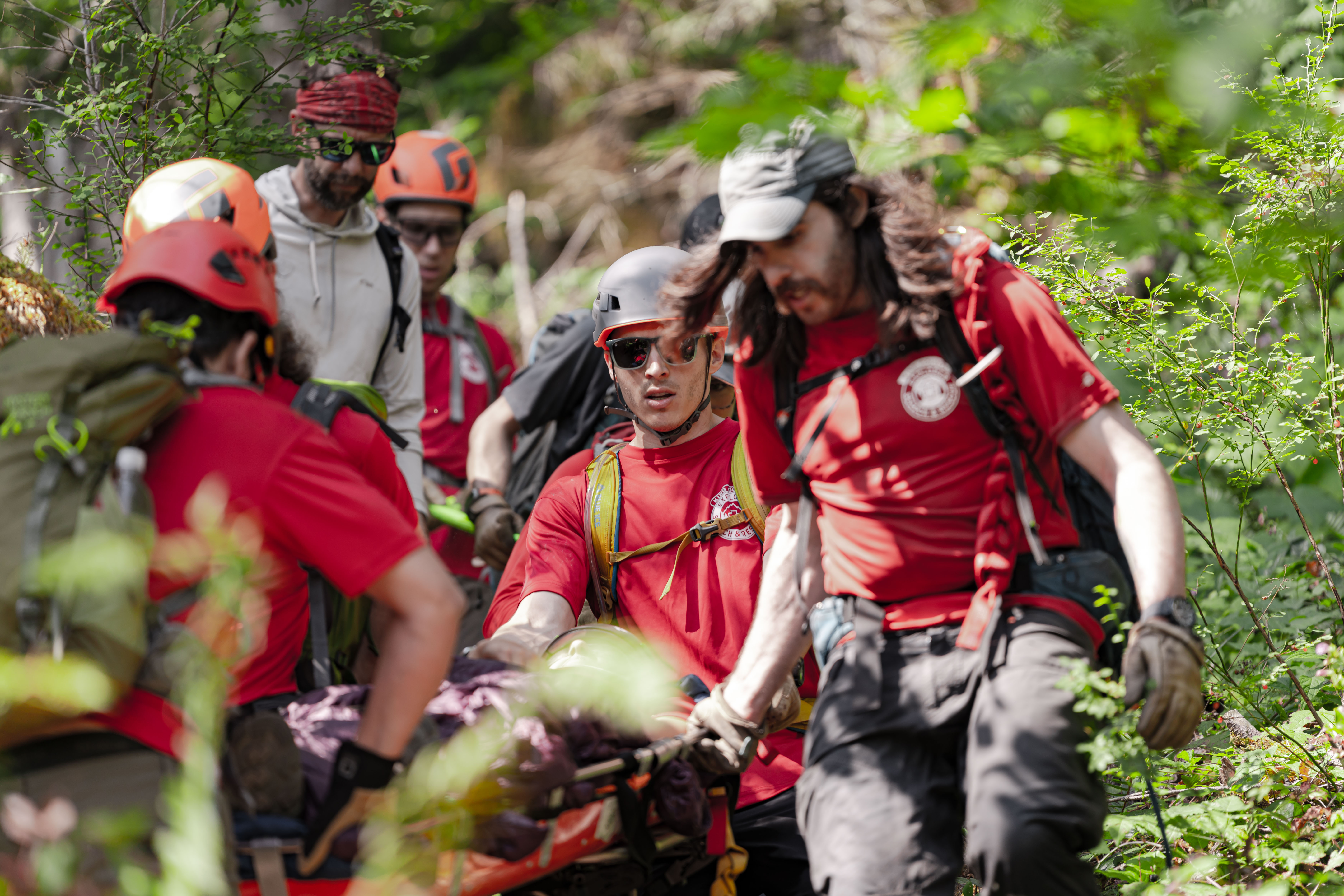 Rescuers packing out a subject in a litter in the forest