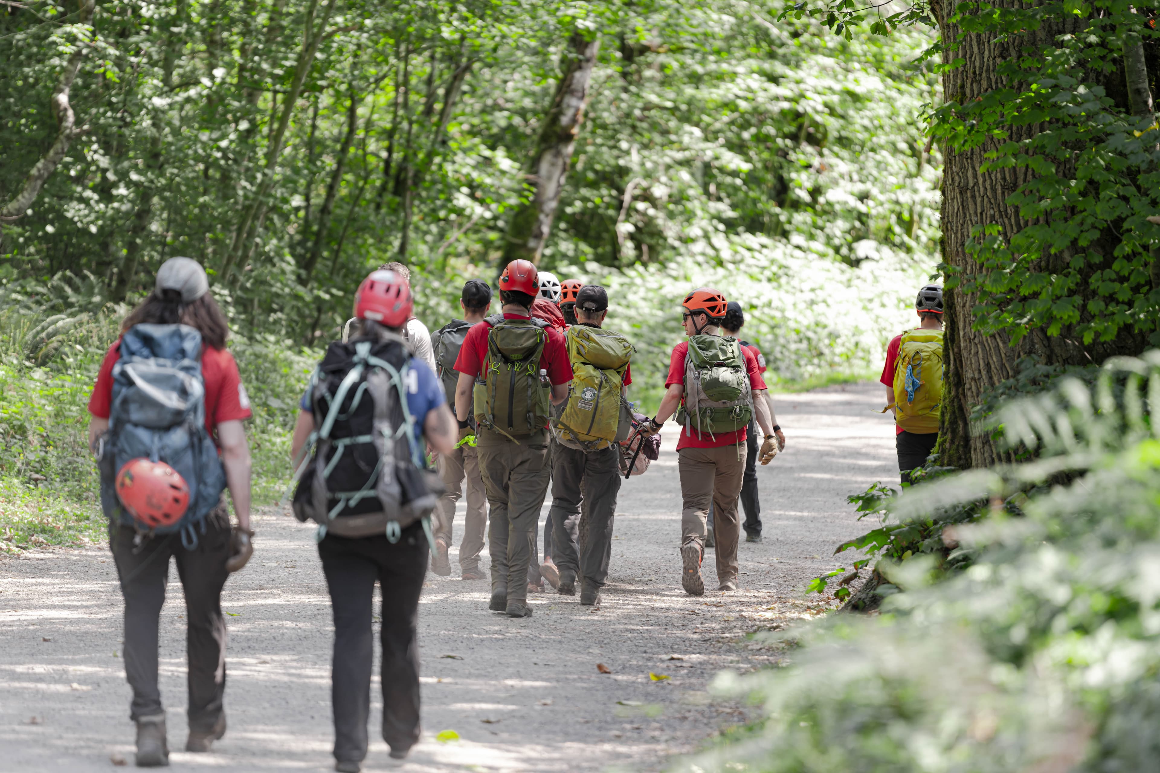 Rescuers walking up a snowy trail